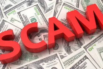 QNET Scam notice, scam text on money background.