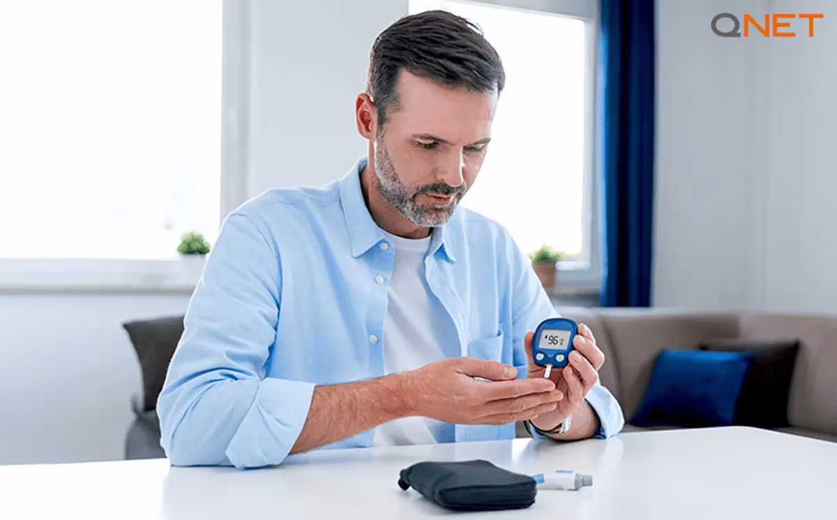 An aged man checking his blood sugar level for diabetes