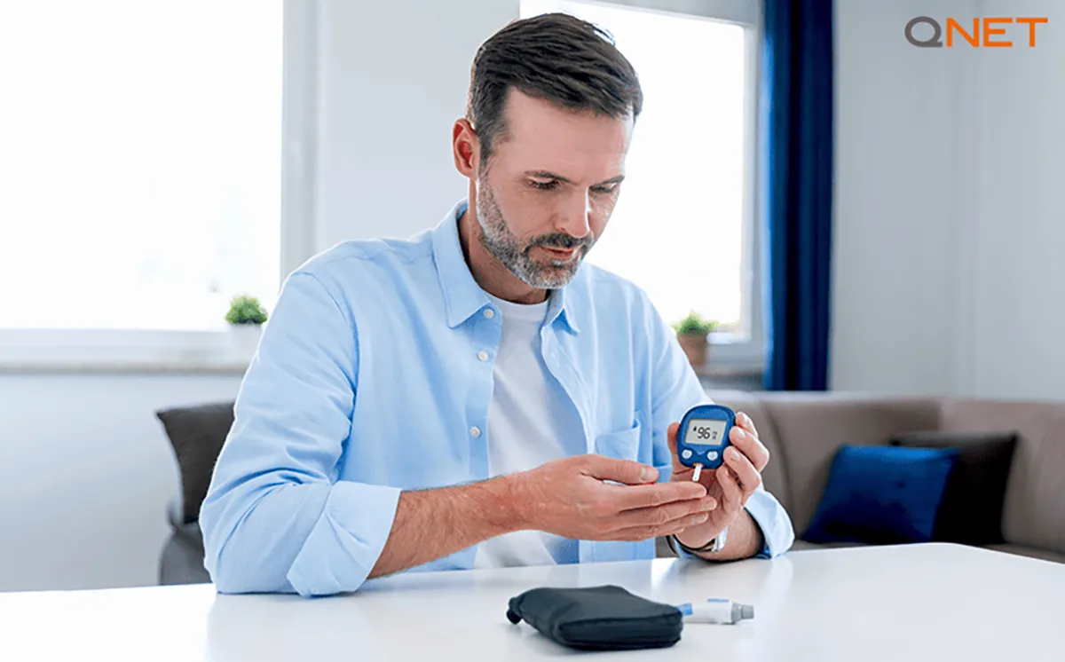 An aged man checking his blood sugar level for diabetes