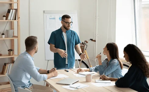 man standing in front of a group people explaining