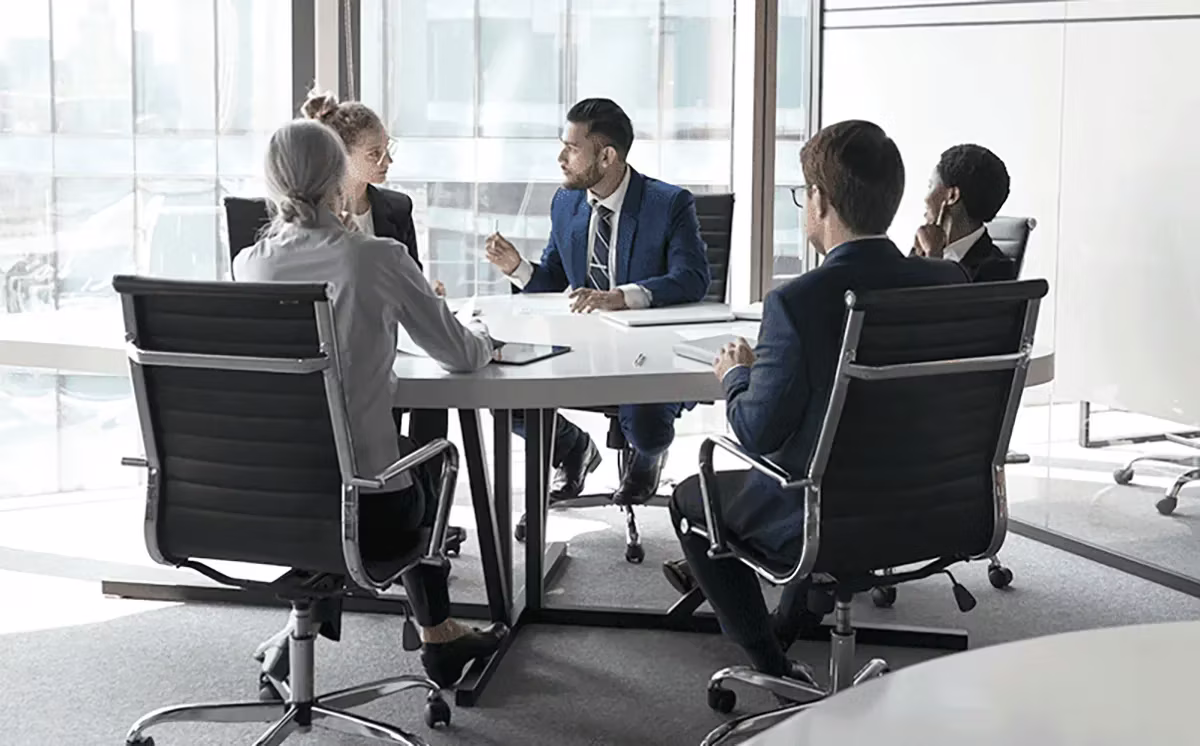 office people sitting at a table meeting
